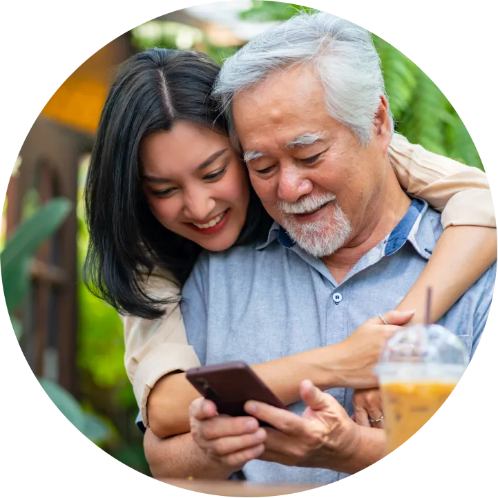 A man and a woman looking at a cell phone.