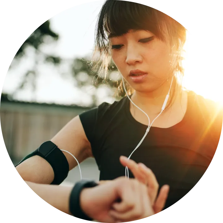 A woman is listening to music with headphones.