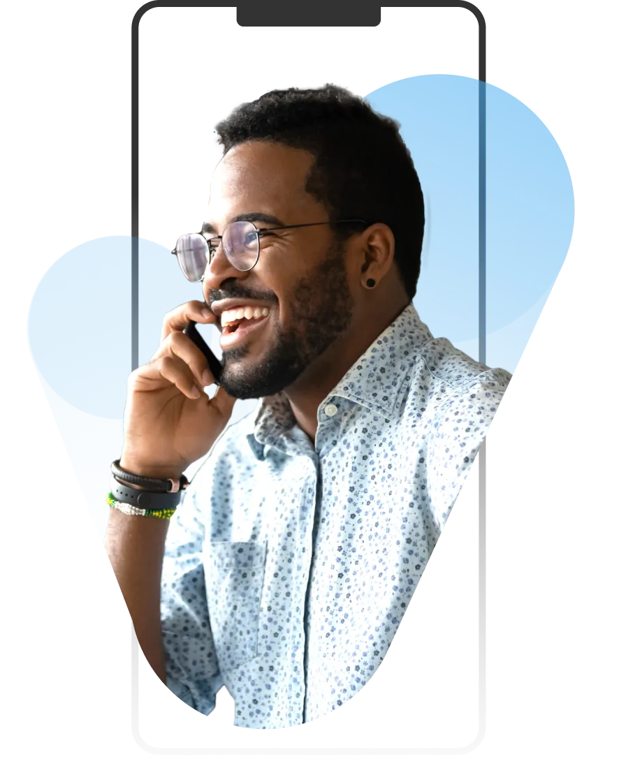 A man with glasses talking on a cell phone.