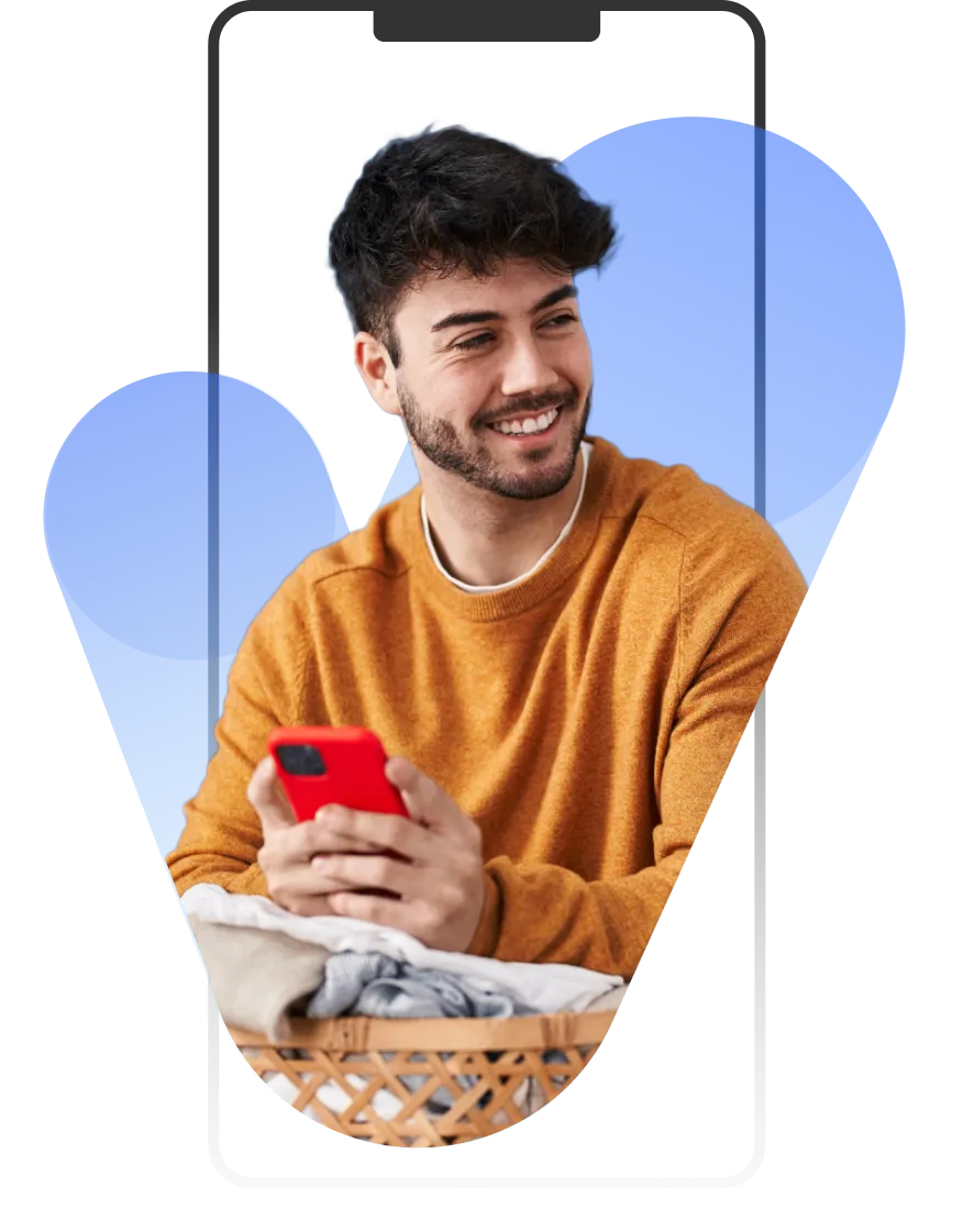 A man holding a red cell phone in his hand.