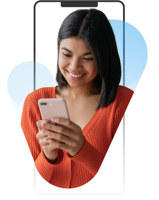 A girl looking at her phone and smiling